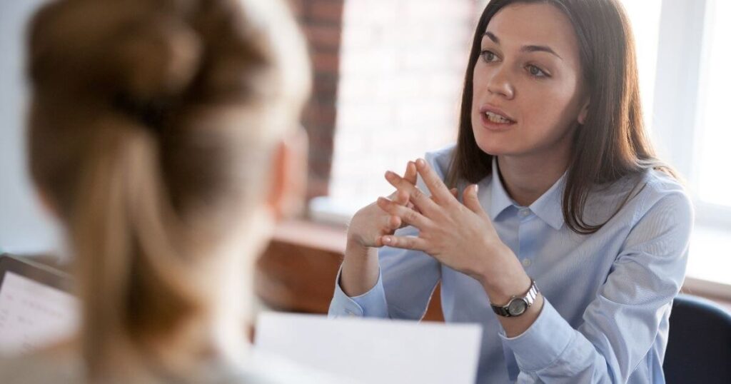 A lady taking part in a conversation with her peers